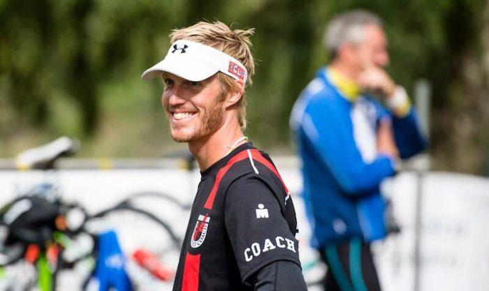 smiling personal trainer outside with hat